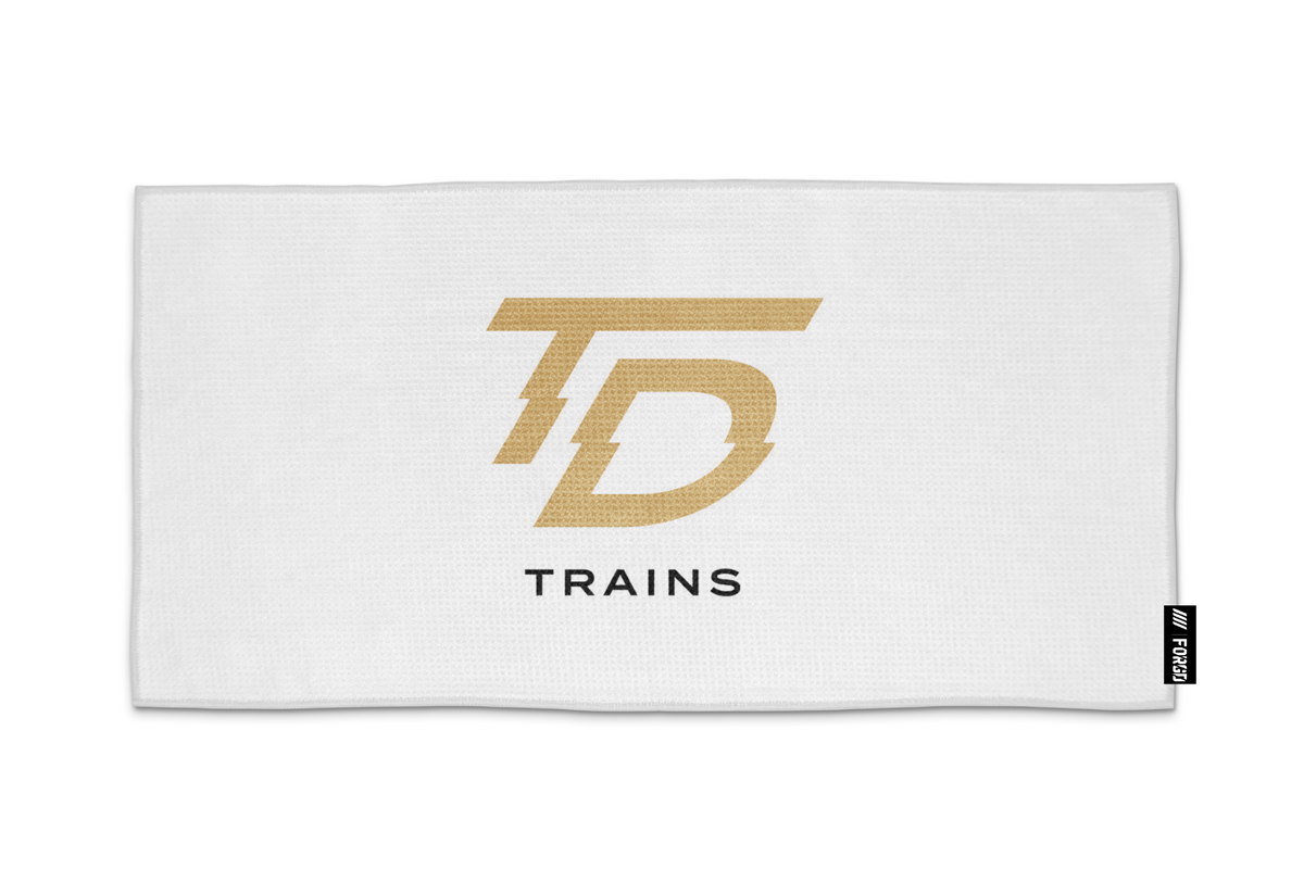 Gold and black TD Trains design on a white 15 by 30 inch FORGD towel